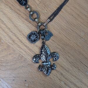 Metal fleur de lis necklace with charms